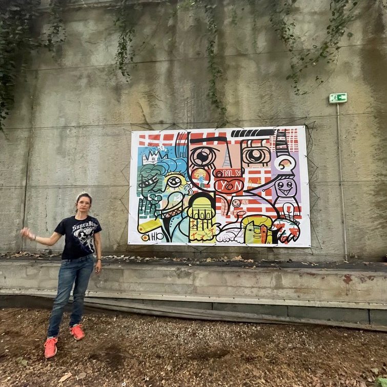 My Digital Mural 9 Ana digital artist Posing in front of a printed collaborative remote artwork Exhibit to enhance workspace aesthetics